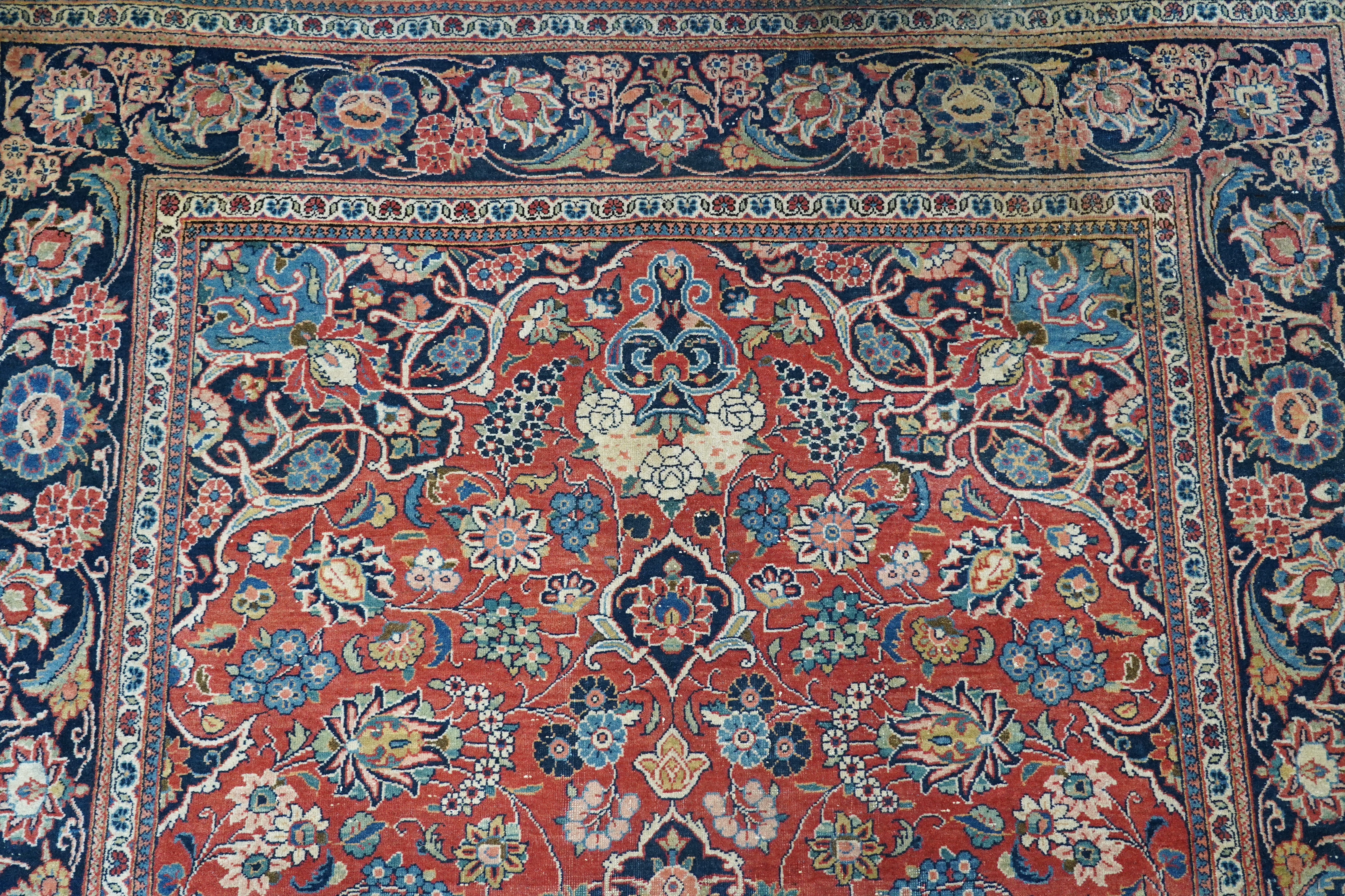A pair of antique Tabriz brick red ground rugs, 200 x 136cm. Condition - fair